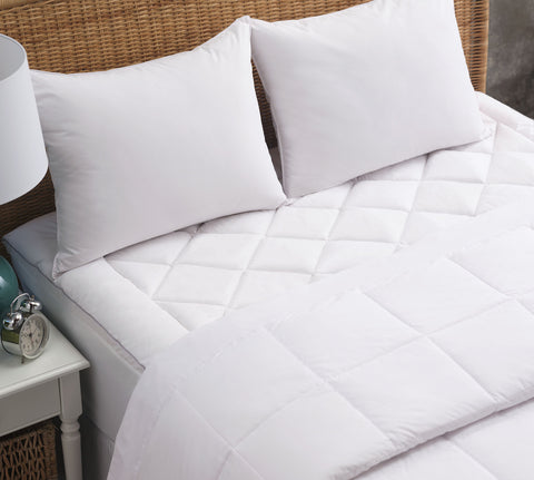 PureAssure Allergen Barrier Deluxe Blanket laying on the bed and folded over about halfway down the bed. Squares stitched into the blanket.