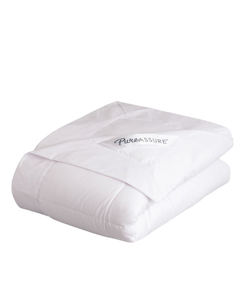 PureAssure Allergen Barrier Deluxe Blanket folded up and on top of the last fold is tag that says "PureAssure" in black text.