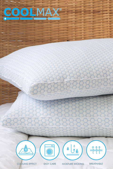 Two CoolMax pillows stacked atop one another. The top pillow slightly askewed. The photo focusing on the left sides of the pillow, getting  aside view of the longer side of the pillows. The pillow features a distinctive white and blue dotted pattern on the pillows. On the top left corner of the image is the word "COOLMAX" in blue letters going from a darker blue to a lighter blue with each letter. Listed on bottom of image is features of the pillow. Moisture Wicking, Breathable, Cooling Effect, & Easy Care.