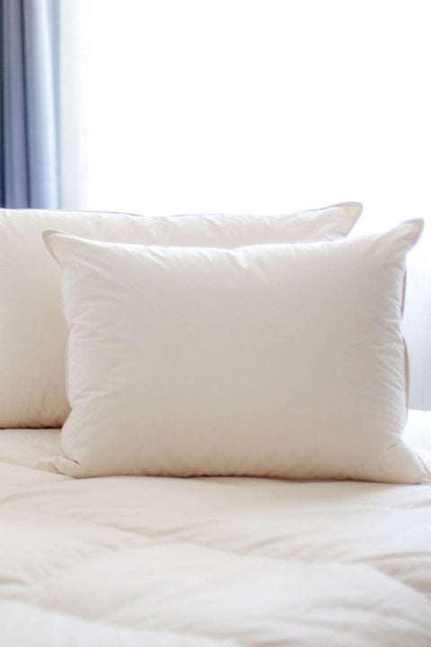 Organic Cotton Down-Free Pillow made with 100% organic cotton, this 233 Thread Count. Two pillows in the picture standing up, they're white with a pinkish hue.