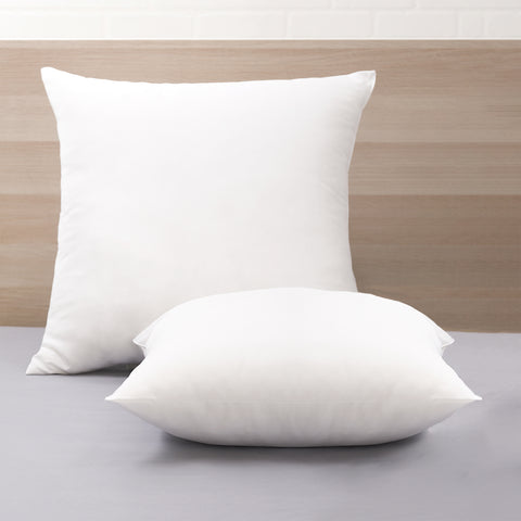 Two Cozy Clouds Cloud9 Euro Dream Pillows one sitting perfectly straight on the headboard and the other laying flat in front of the first pillow. Both pillows are perfect white squares. 