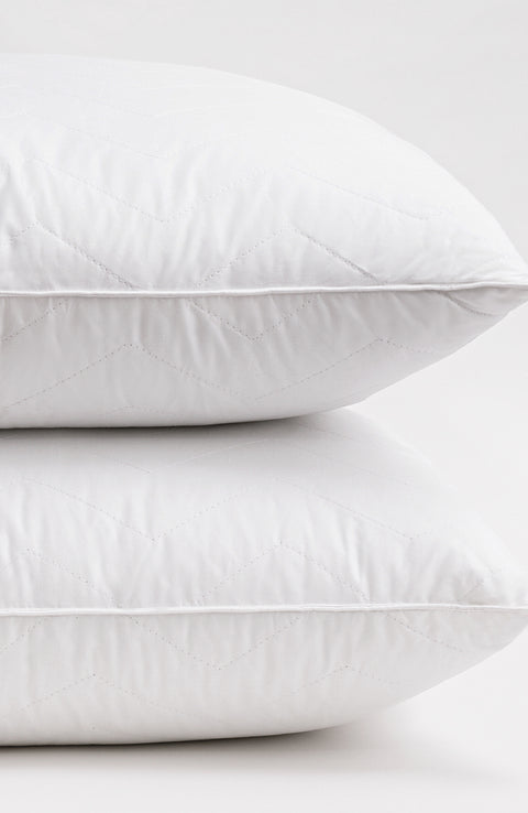 Herringbone Quilted Pillow 2-Pack one on top of the other on a white background. The pillows have several horizontal lines running across it, with V shapes alternating facing up and down.