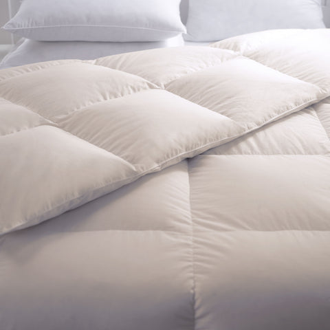 The Organic Cotton Down-Free Comforter laying flat with the corner folded over. Easily able to see the square design across the whole comforter.