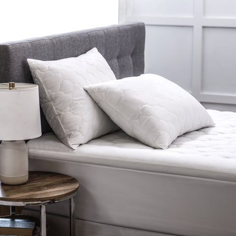 Two gorgeous Billowy Clouds Pillows on a bed. Side profile of the  4 inch quilted cloud pattern and is filled with high-quality, gel-fiber polyester filling with a 300 thread count cotton 