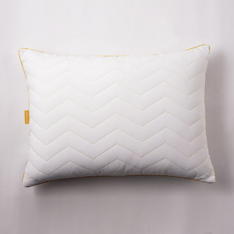 There is a single Simmons Cooling Herringbone Pillow in this image. Getting a Birdseye view of the pillow. Laying flat on a white background. The pillow has the classic Simmons' yellow lining on the edges, with the yellow Simmons' tag on it. The pillow has a zig-zag herringbone quilt pattern and is covered by an "cool to the touch" nylon cover. 