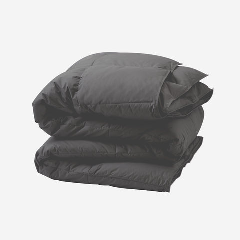 The Graphene Duvet aka the CharcoComforter, folded up with white background. With 420 thread count cover fabric. Large squares stitching running across the whole surface.