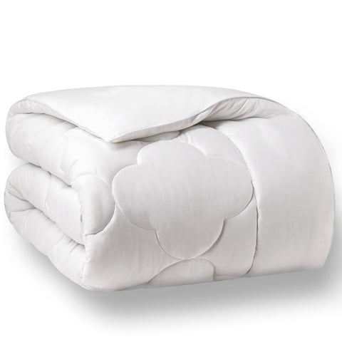 Folded up in center frame of a white background image, is a comforter with 8 inch frame with a 10 to 13 inch quilted cloud pattern in the center and is filled with high-quality, gel-fiber polyester filling with a 300 thread count cotton.