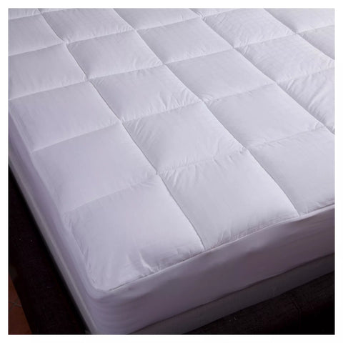 Image of the corner of a bed from the top view with 300 thread count cotton, with a  dobby window pane design. The mattress pad is equipped with a stretch skirt that can accommodate mattresses up to 21" in size. 