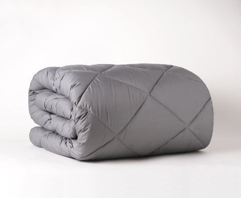 The Graphene Mattress Pad aka the CharcoMattressPad, is shown with folded up nicely with white backround. With 420 thread count cover fabric. Large diamonds stitching running across the whole surface.