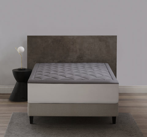 The Graphene Mattress Pad aka the CharcoMattressPad, is shown from the foot of the bed. With 420 thread count cover fabric. Large diamonds stitching running across the whole surface.