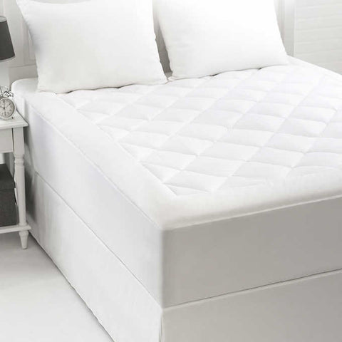 Cozy Comfort Cotton Mattress Pad with diamonds going along the top. The sides have no design. The product is white.