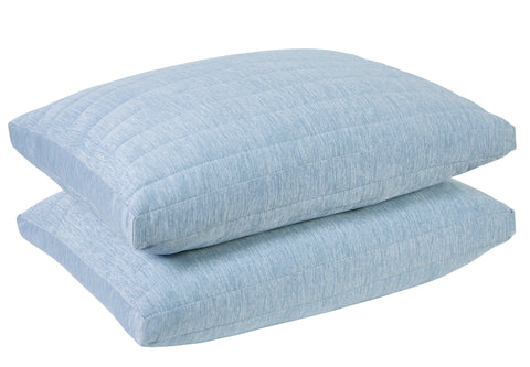 White background with two light blue pillows laying atop one another, laying flat.