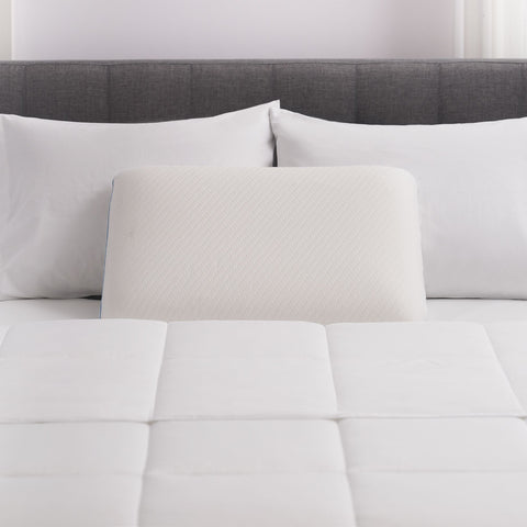 On a back is three pillows. Two classic pillows leaning side by side on the headboard. Then in front of the two, leaning on both pillows, is the pillow we are showcasing. With the distinct mini squares stitched on the entire surface.  