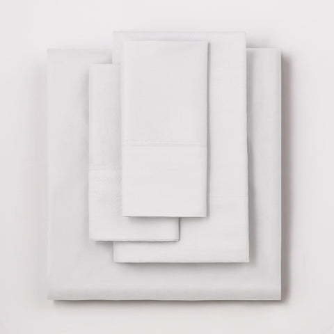 On a white background we have a full set of the White colored Microfiber Sheet Set. All perfectly folded up and layered on top of each other.