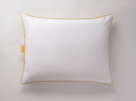 White pillow laying flat on a white surface. Classic Simmon's Yellow line around the ends and a matching yellow Simmons tag on the left side. 230 thread count quilted cover.