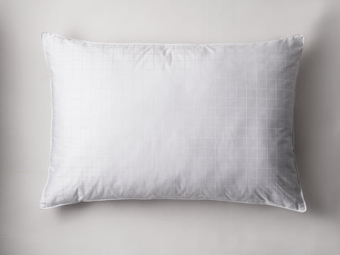 One 80/20 pillow laying flat on a white background. The pillow has texture of white little squares all across.