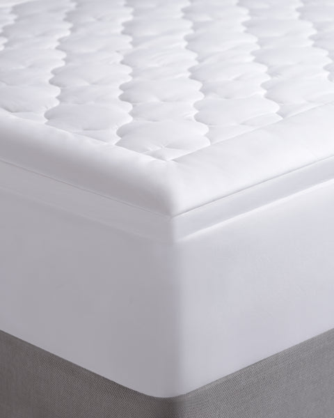 The corner of a Billow Mattress pad, a thick 300-Thread Count cover and Gel Fiber Poly fill.