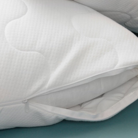 Zoomed in image of a pillow with the zipper of the cover slightly open. Revealing that the cover is have lines that have concaves, alternating up and down. While the pillow itself has none of that.