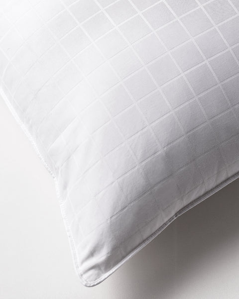 Plush Perfect Gel Fiber Pillow (Overstuffed) (Set of 2), just a corner of one of the pillow shows. Emphasizing the little white square stitching on the pillows.