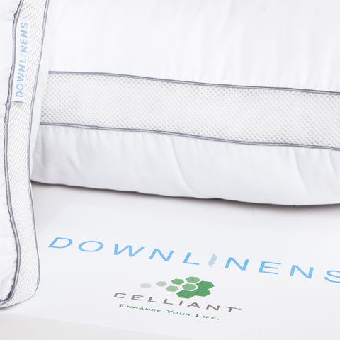 PowerNap Celliant Fiber Blend Pillow (Soft) (Set of 2). Zoomed in on one side of a pillow, where there are two blue parallels lines with little dots filling up the space between. A second pillow just out of frame but a white tag with blue text that reads "DOWNLINENS." Then on the bottom of the image you can see in blue text in large letters is "DOWNLINENS" with a green logo with the word "CELLIANT" written in grey text below the logo.