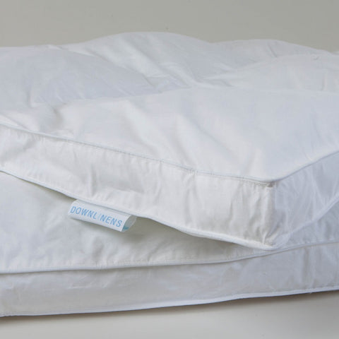 Zoomed in image Down Free Fiber Bed but just the corner. With a white tag and blue letter that say "DOWNLINENS."