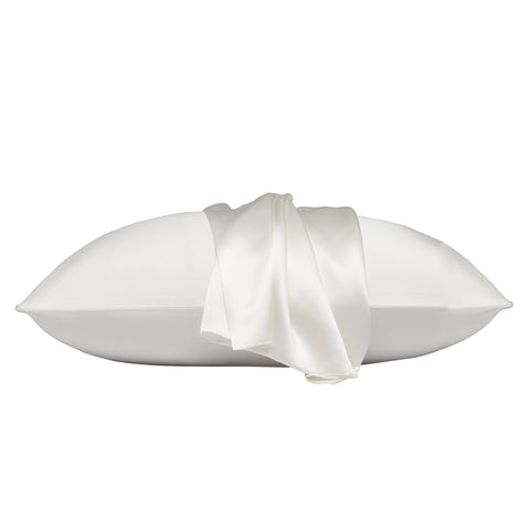 On a white background is a pillow laying flat. The pillow is in the ivory silk pillow case, with another ivory pillow case on the center of the pillow, overlapping on itself.