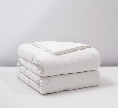 The Superior Queen Down Comforter- RDS Certified folded up with a little triangle folded over itself on the top.