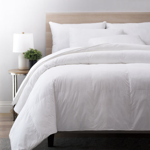 Picture displayed a made bed with the Superior Queen Down Comforter- RDS Certified on top. The comforter is folded over itself at the head of the bed. There are also pillows t the head of the bed to give the full effect of what the comforter would look on a made bed.